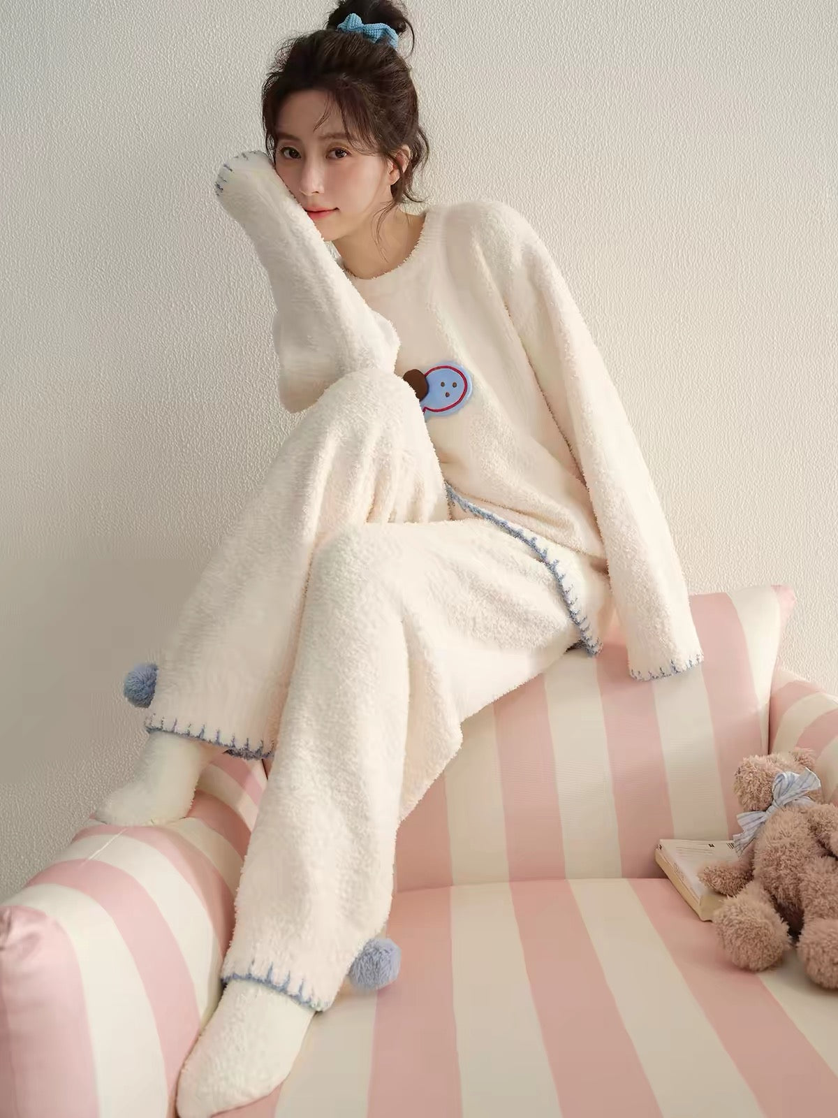 Soft, fluffy fleece pyjama set with a round neck, pom-pom and blue stitching. Warm, cozy winter loungewear from Rosie Rue.
