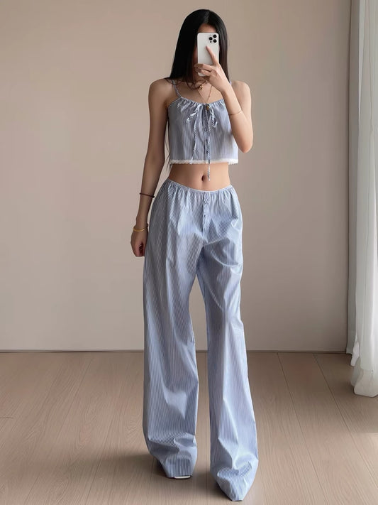 Woman wearing blue striped cropped cami with bow and lace hem and matching wide-leg pajama pants