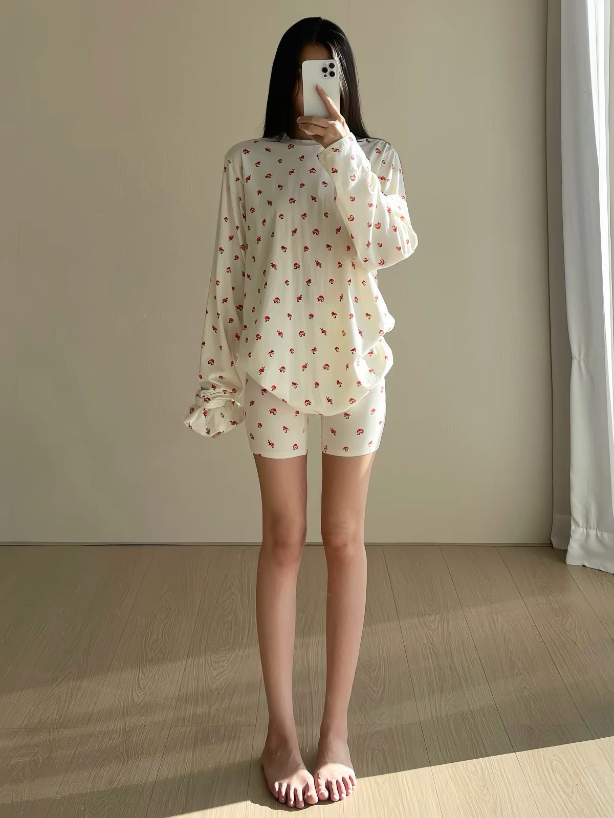 Cream long-sleeve pajama top and matching shorts with small red strawberry print